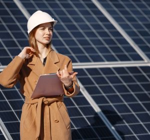 Businesswomen working on checking equipment at solar power plant. With tablet checklist, woman working on outdoor at solar power.